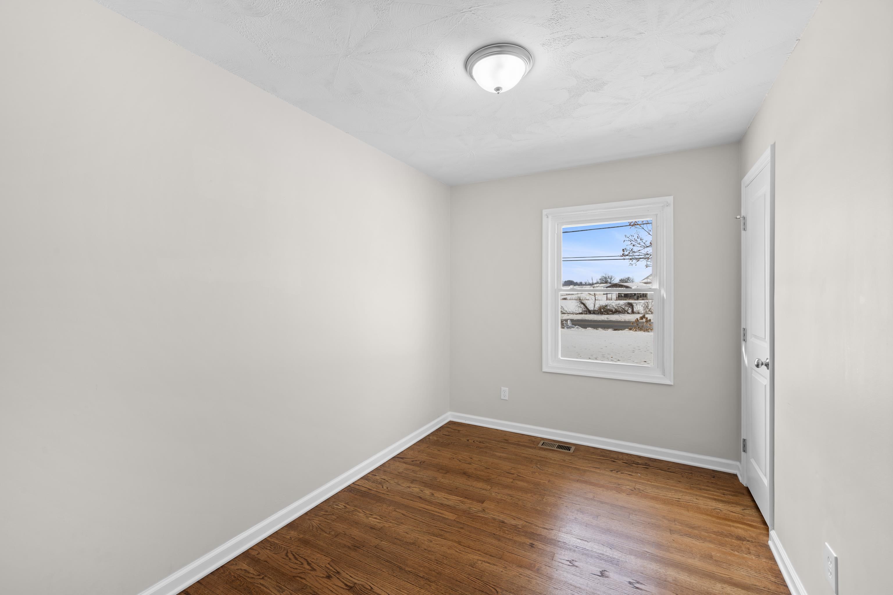 7540 Spring Creek Road Bridgewater, VA 22812 - Photo 20 of 42 an empty room with wooden floor and window