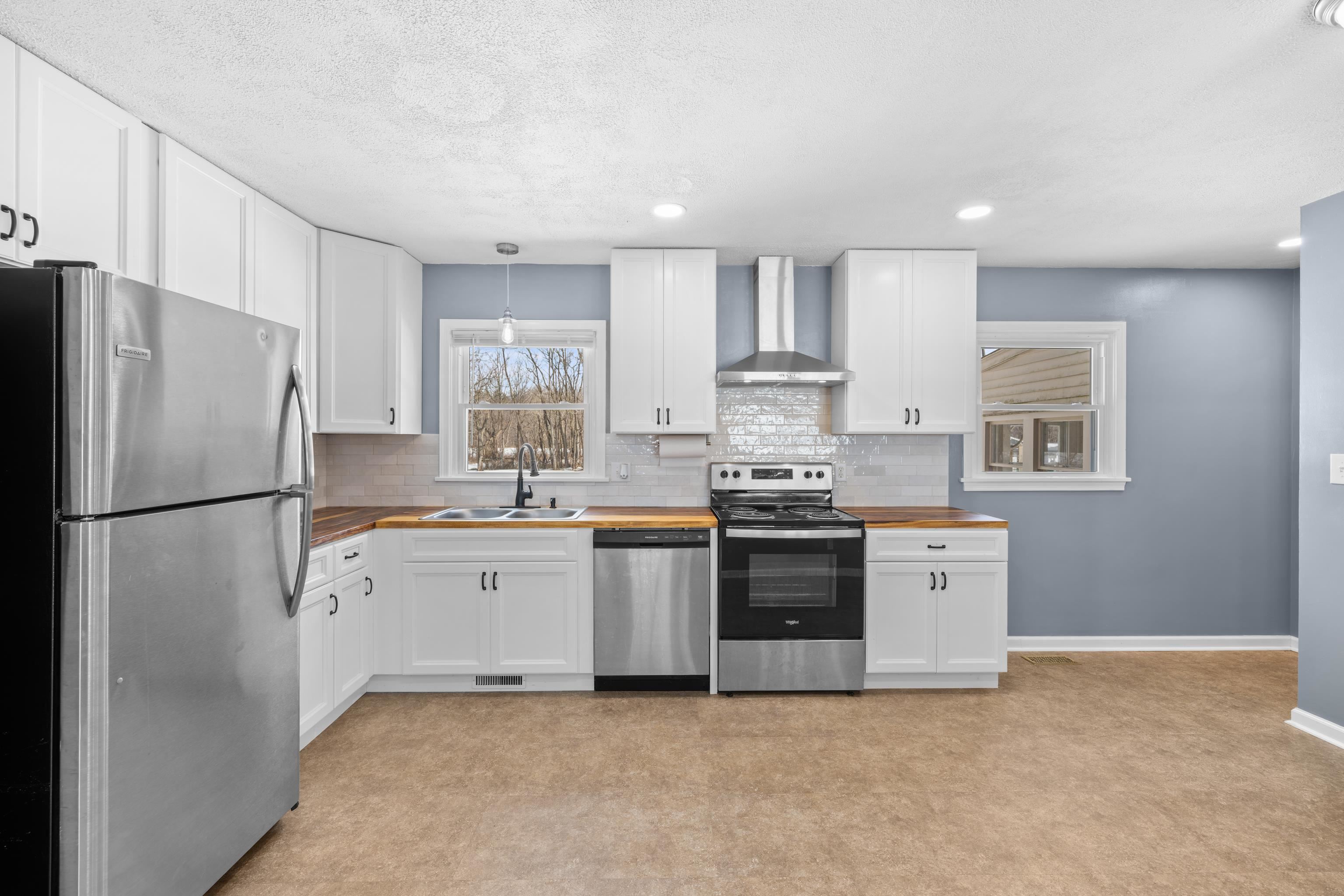 7540 Spring Creek Road Bridgewater, VA 22812 - Photo 9 of 42 a kitchen with stainless steel appliances white cabinets and a refrigerator