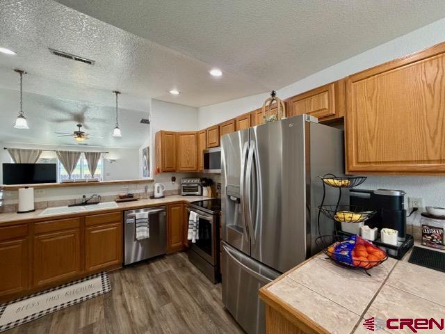 544 20th Street Delta, CO 81416 - Photo 9 of 44 a kitchen with stainless steel appliances a sink cabinets and wooden floor