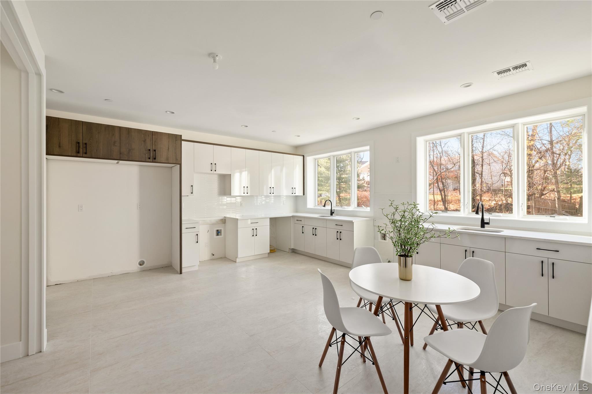 7 Valley Way, Unit 321 Spring Valley, NY 10977 - Photo 11 of 41 a kitchen with stainless steel appliances a dining table and chairs