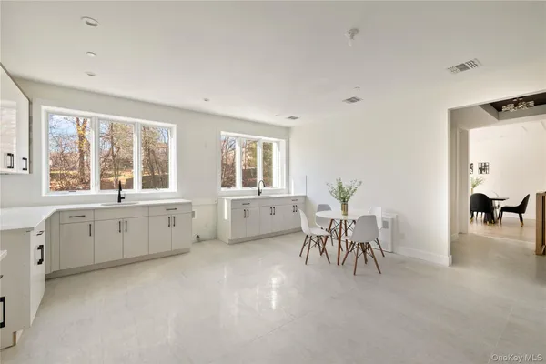 a large white room with furniture and windows