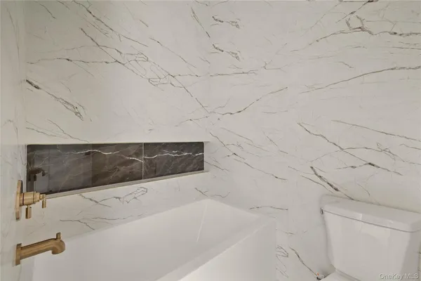 a bathroom with bathtub and vanity
