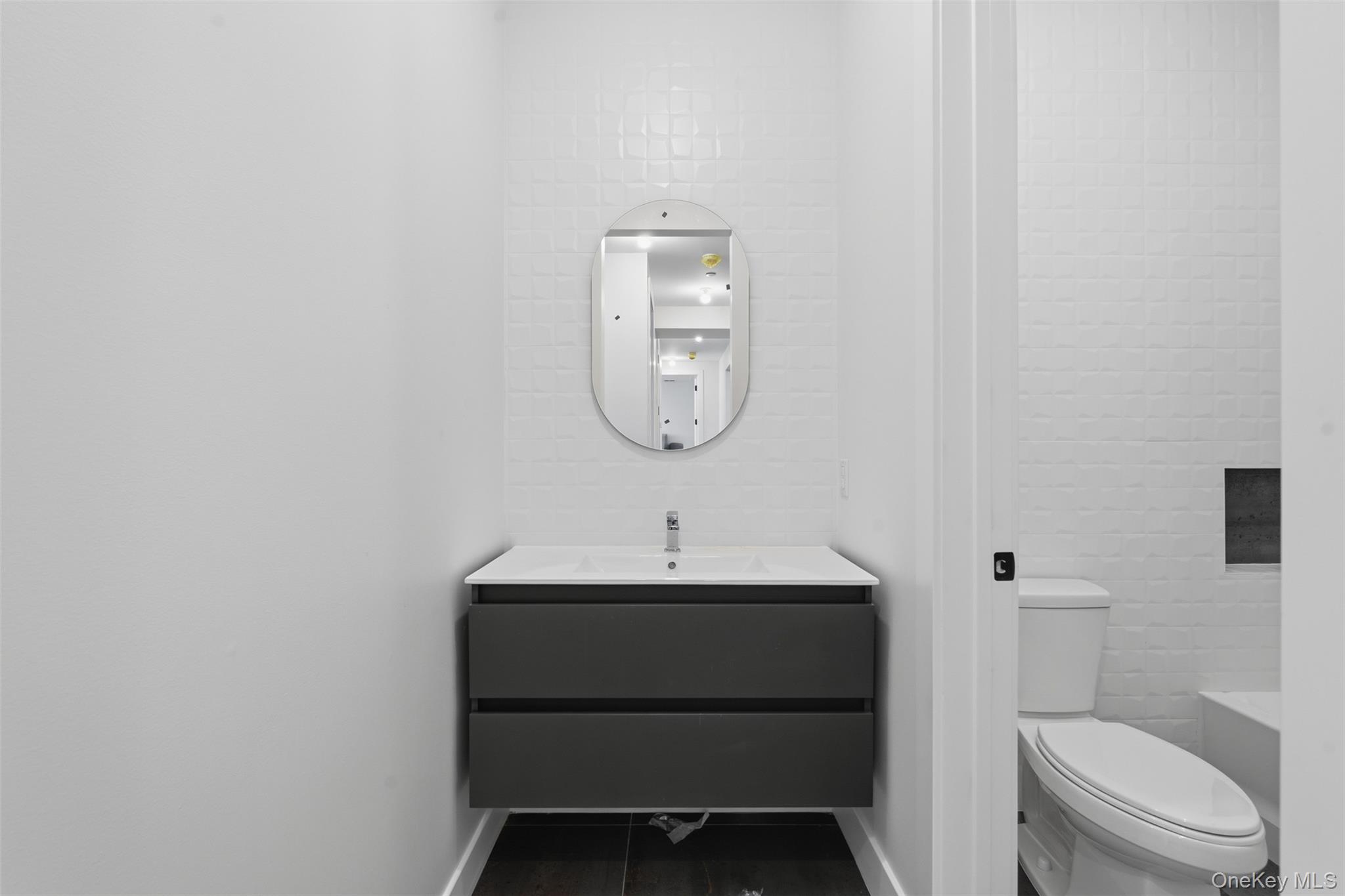 7 Valley Way, Unit 321 Spring Valley, NY 10977 - Photo 46 of 50 a bathroom with a sink toilet and a mirror