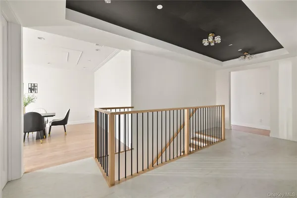 a view of a hallway with couches and a potted plant