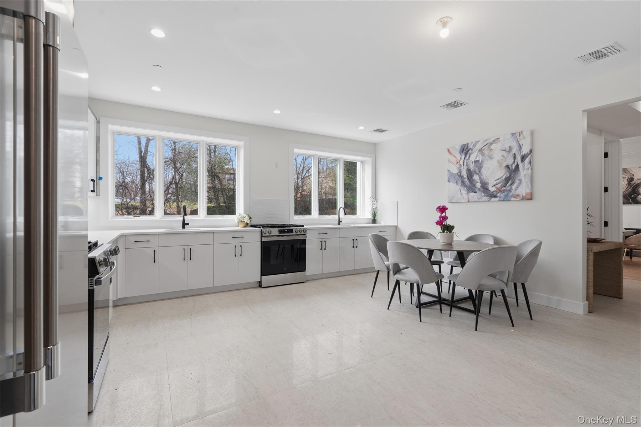 7 Valley Way, Unit 321 Spring Valley, NY 10977 - Photo 10 of 50 a large kitchen with a table and chairs