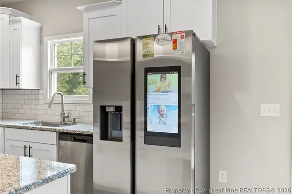 a kitchen with a sink a refrigerator and window