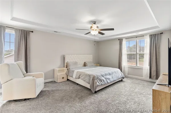 a spacious bedroom with a bed and a couch