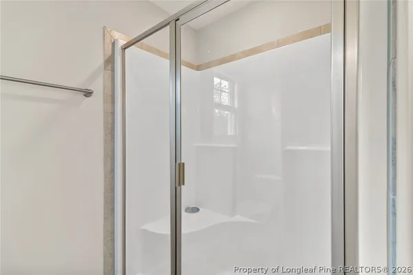 a bathroom with a glass shower door
