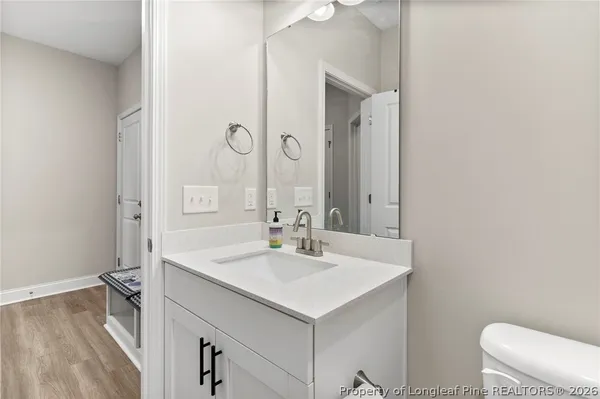 a bathroom with a sink a toilet and a mirror