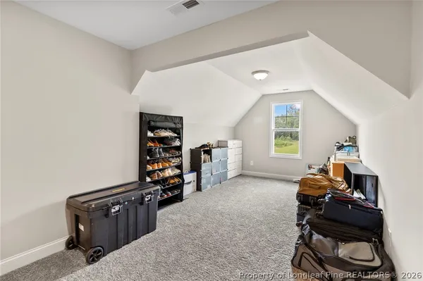 a living room with furniture a window and gym equipment
