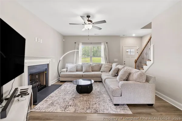 a living room with furniture fireplace and a flat screen tv