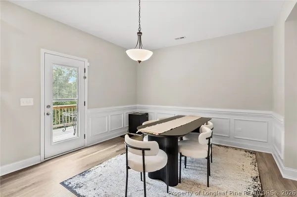 a view of a dining room with furniture and wooden floor