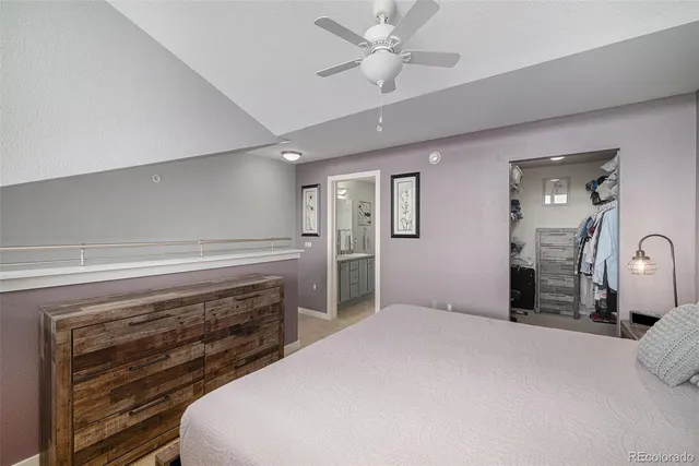 a spacious bedroom with a bed and a chandelier