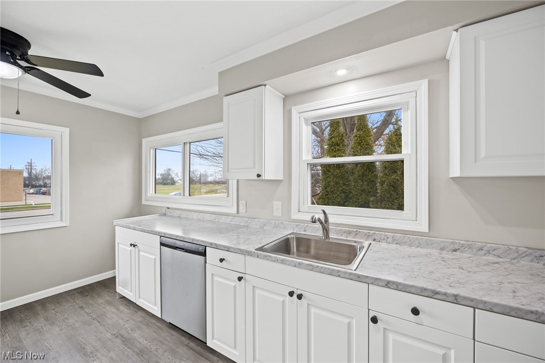 11417 Snow Road Parma Heights, OH 44130 - Photo 4 of 32 Eat-in kitchen with plenty of natural light, white cabinets, dishwasher, and ceiling fan