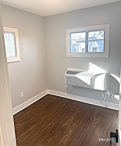 a bathroom with a sink and mirror with toilet