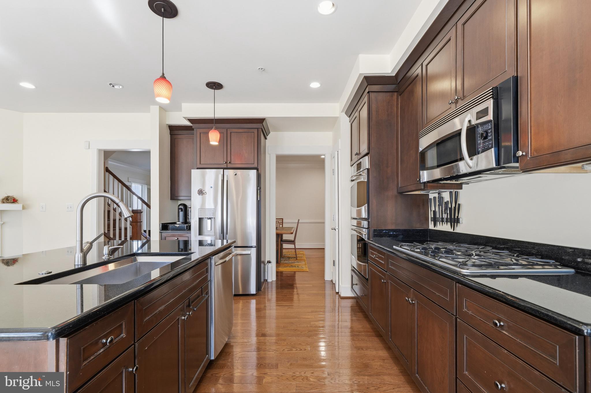 9530 Ament Street Silver Spring, MD 20910 - Photo 9 of 55 a kitchen with stainless steel appliances a sink stove and refrigerator
