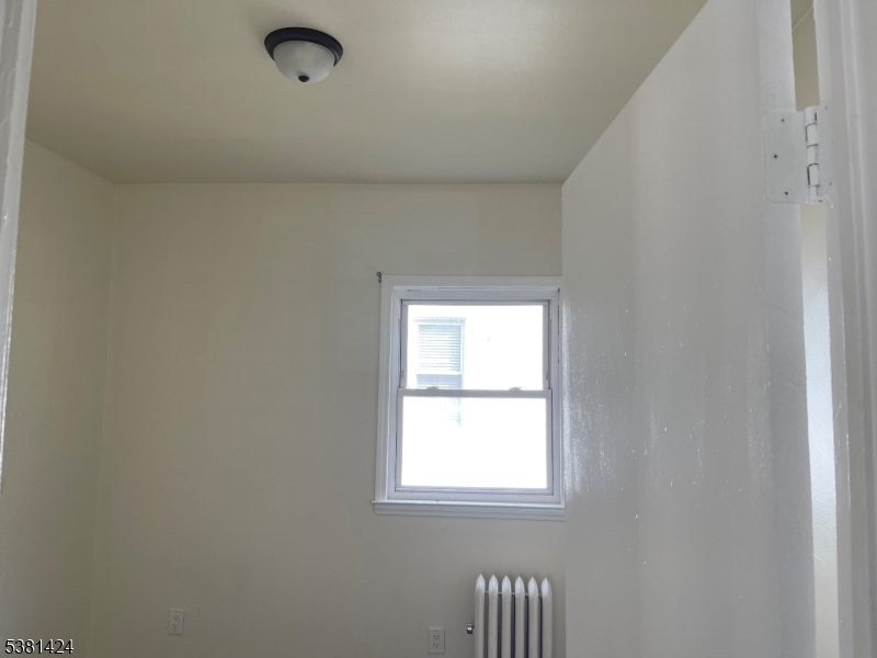 242 Union Avenue Paterson, NJ 07502 - Photo 3 of 10 an empty room with a window