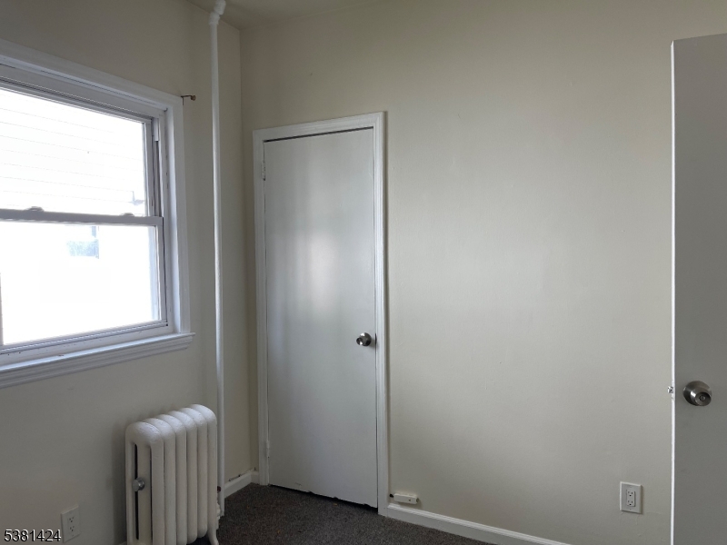 242 Union Avenue Paterson, NJ 07502 - Photo 5 of 10 a view of an empty room with a window