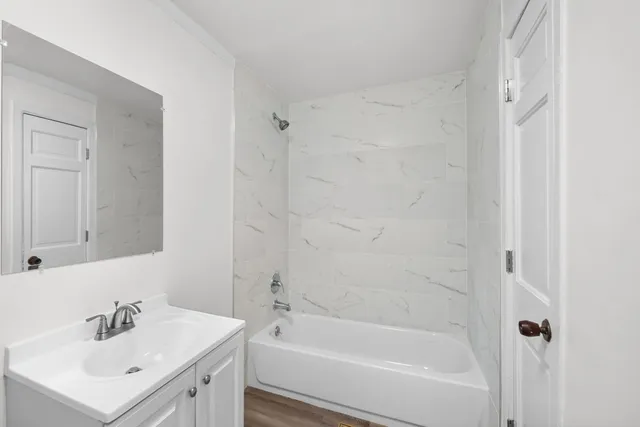 a white bath tub sitting next to a white sink