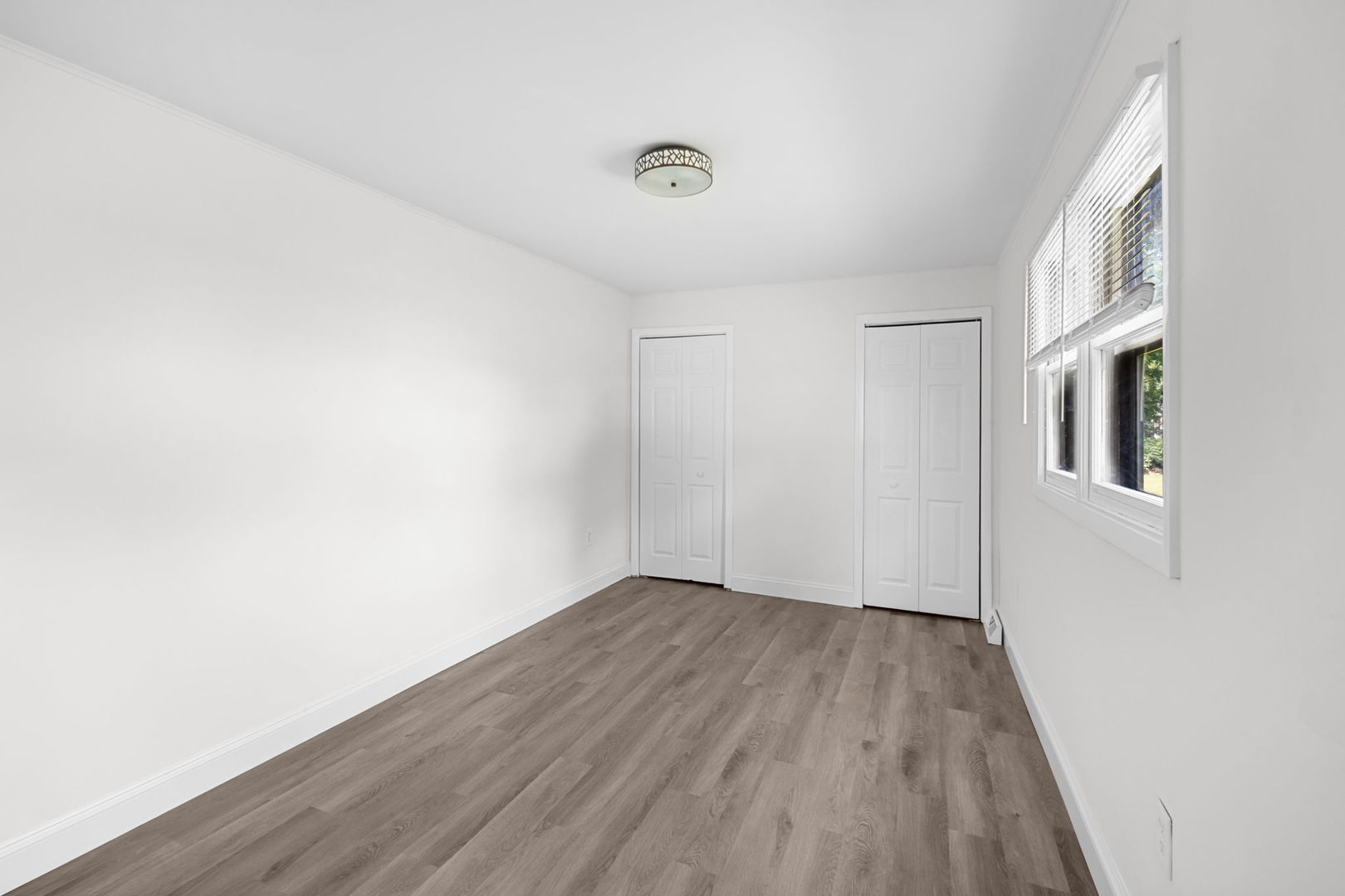 37714 North Nippersink Place Spring Grove, IL 60081 - Photo 6 of 16 a view of an empty room with wooden floor and a window