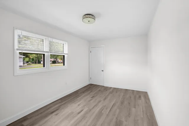 a view of a room with wooden floor and window