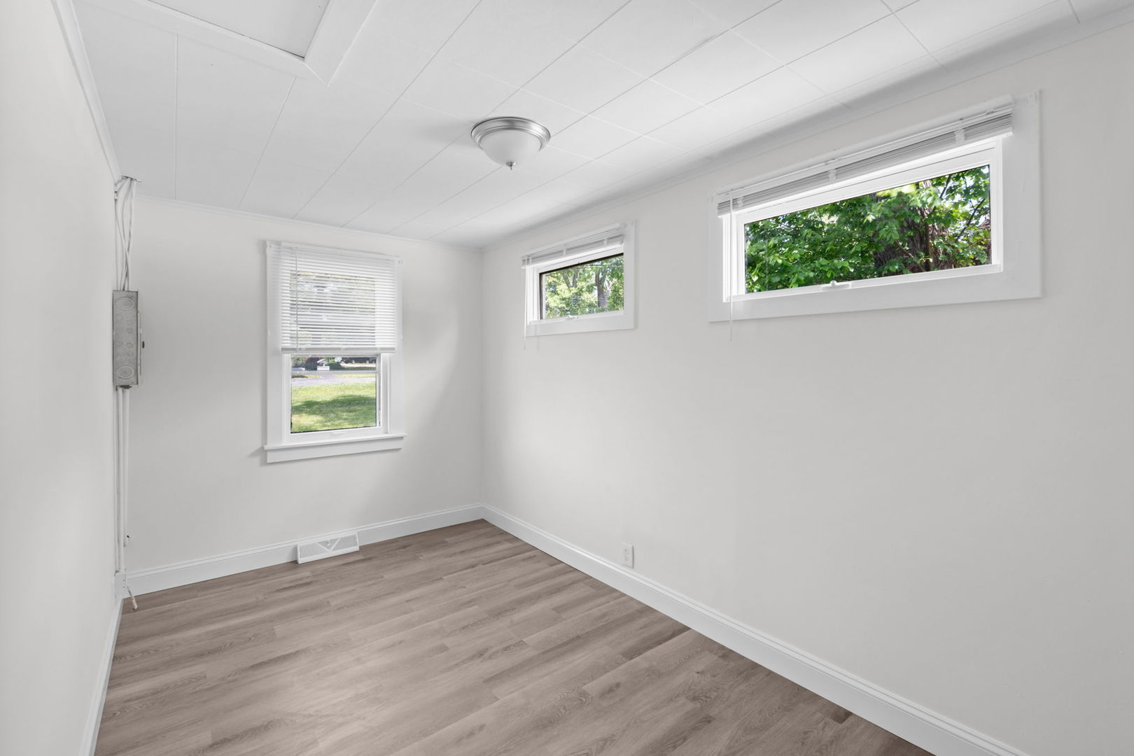 37714 North Nippersink Place Spring Grove, IL 60081 - Photo 8 of 16 a view of an empty room with wooden floor and a window