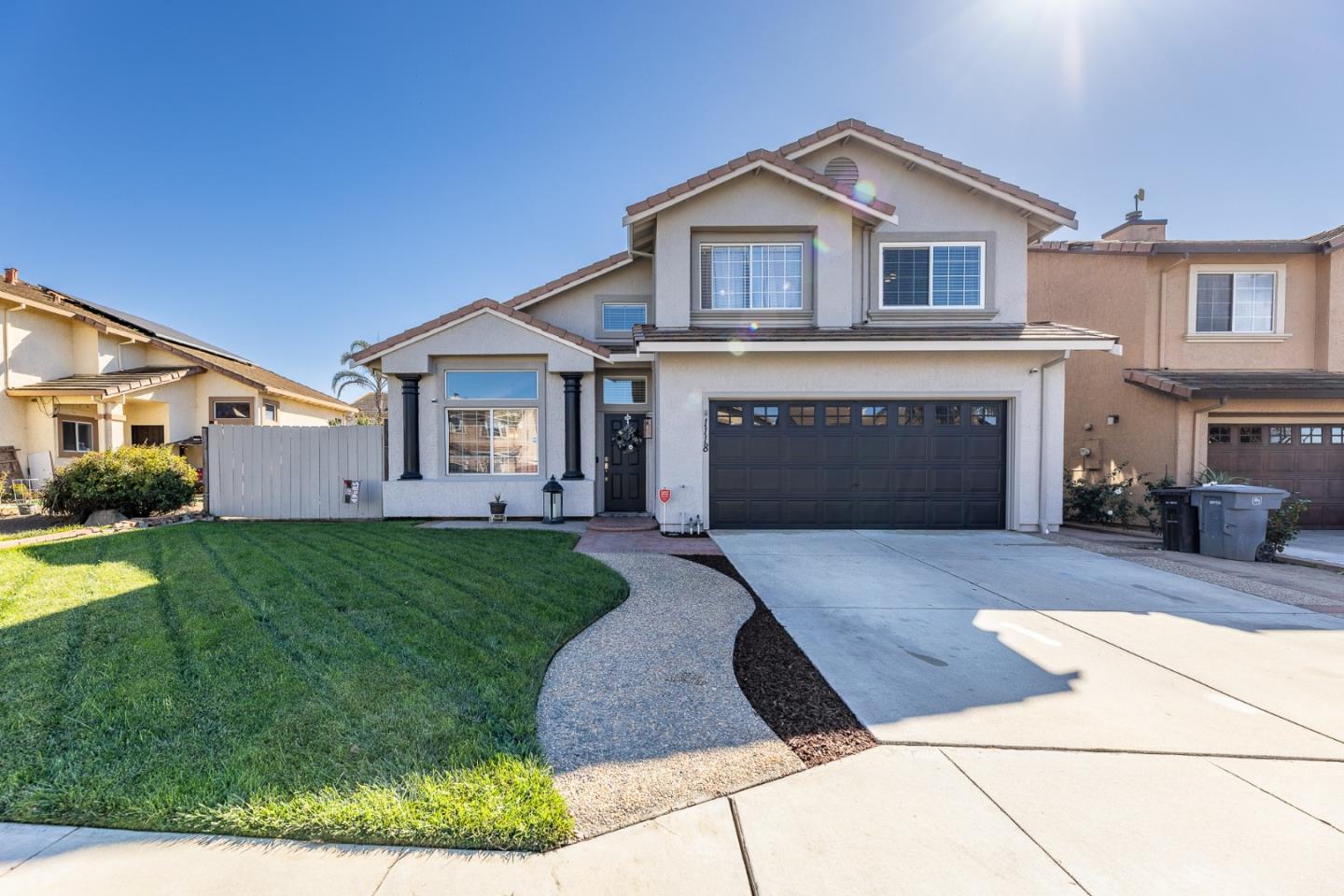 a front view of a house with a garden and yard