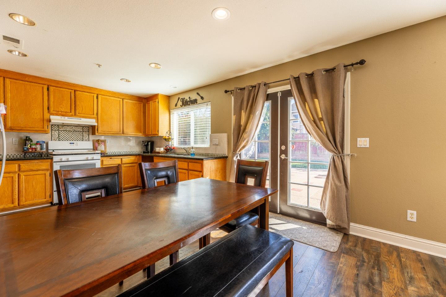 1118 Eagle Drive Salinas, CA 93905 - Photo 12 of 30 a kitchen with stainless steel appliances granite countertop a sink counter space and wooden floor