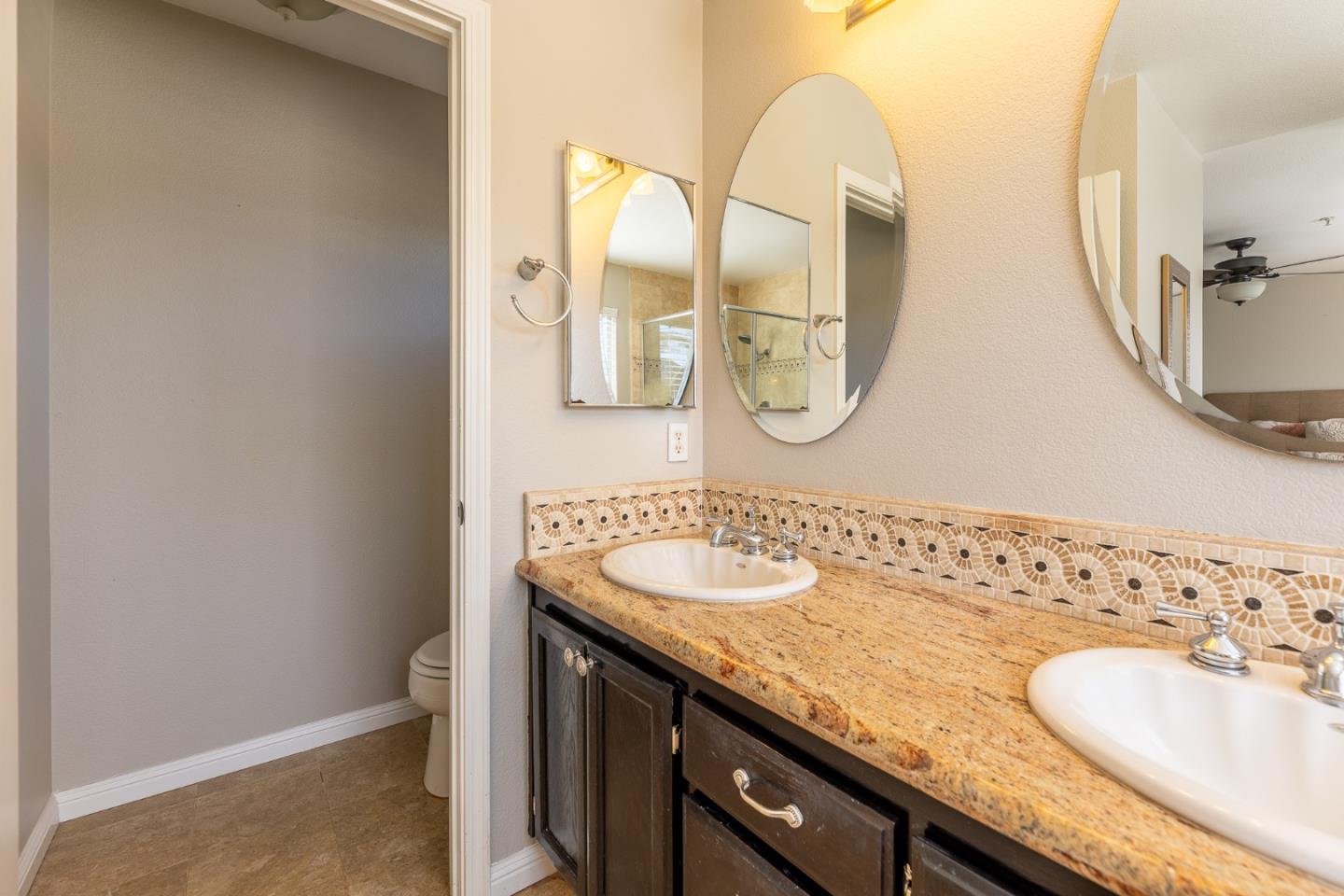 1118 Eagle Drive Salinas, CA 93905 - Photo 19 of 30 a bathroom with a granite countertop sink and a mirror