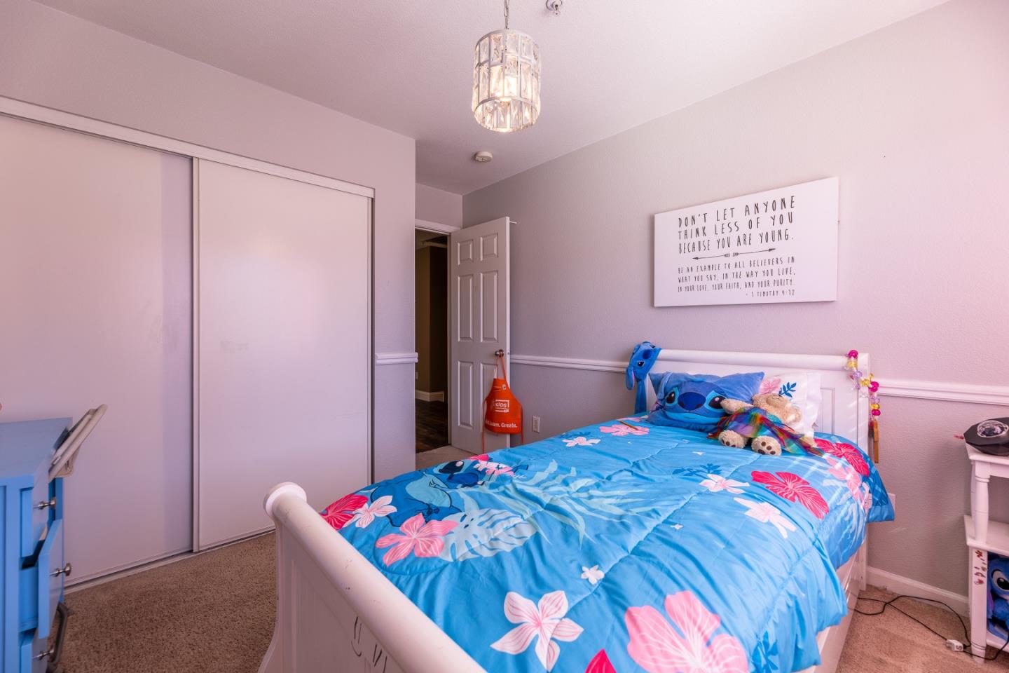 1118 Eagle Drive Salinas, CA 93905 - Photo 21 of 30 a bedroom with a bed and a chandelier