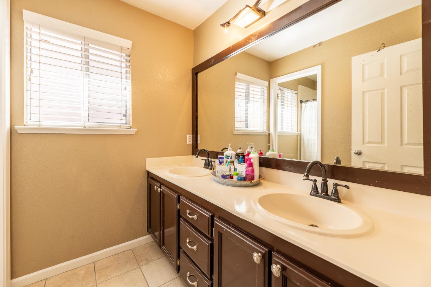 1118 Eagle Drive Salinas, CA 93905 - Photo 23 of 30 a bathroom with a granite countertop sink and a mirror