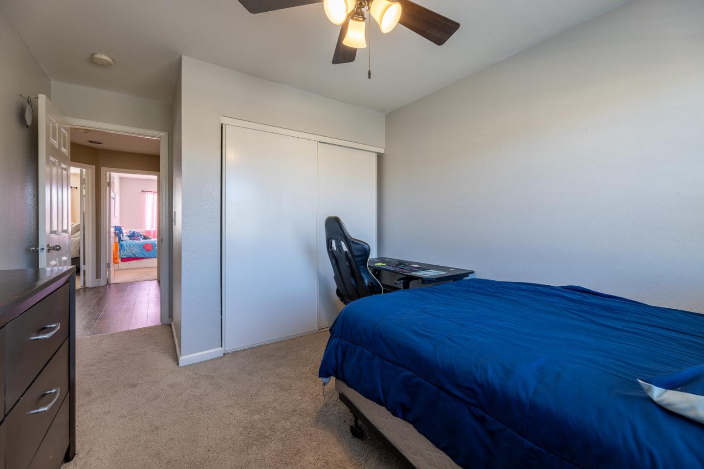 1118 Eagle Drive Salinas, CA 93905 - Photo 26 of 30 a bedroom with a bed and a chandelier