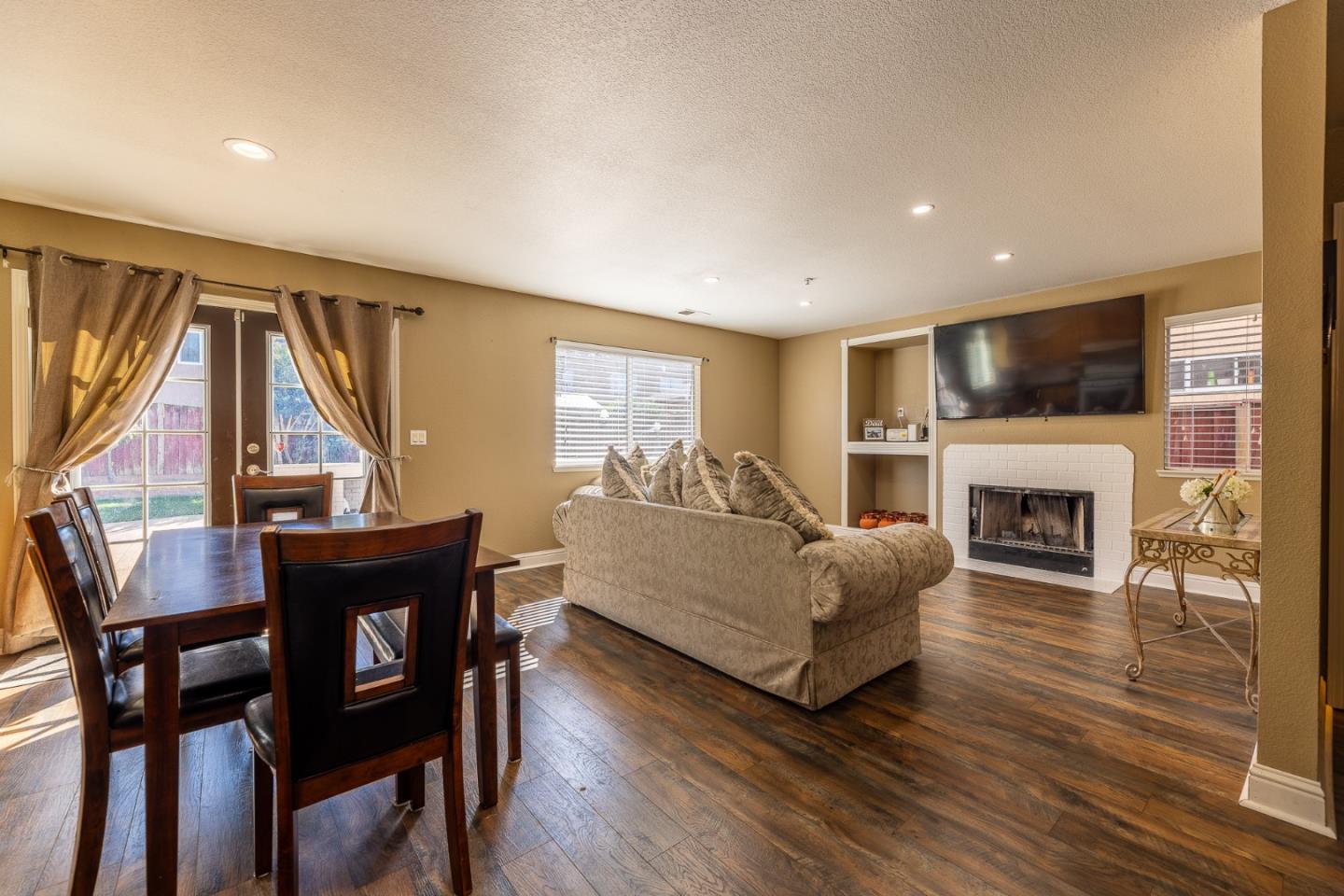 1118 Eagle Drive Salinas, CA 93905 - Photo 8 of 30 a living room with furniture a fireplace and a flat screen tv