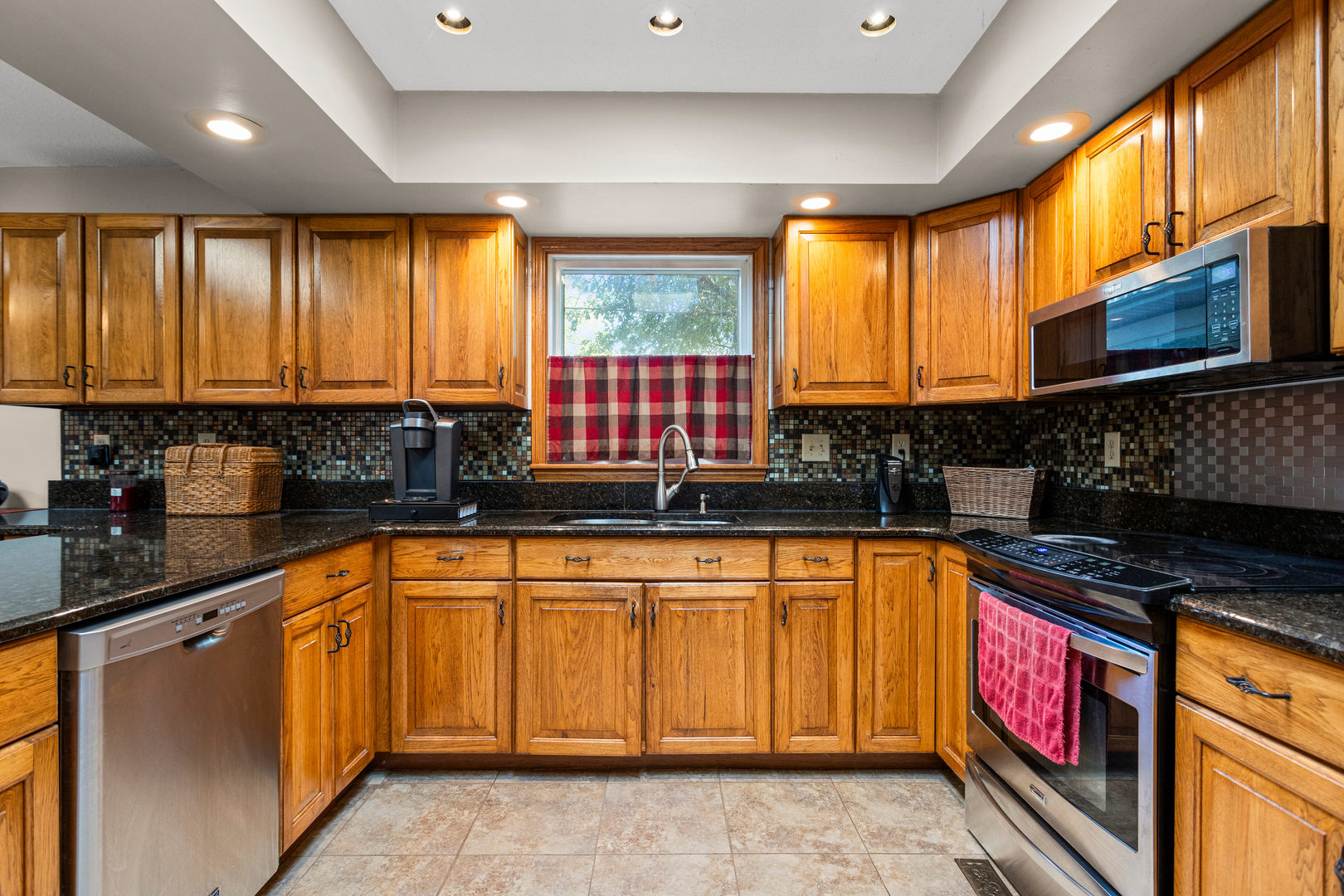 2073 Coyote Run Road Monticello, IL 61856 - Photo 12 of 42 a kitchen with stainless steel appliances granite countertop a stove a sink and a microwave