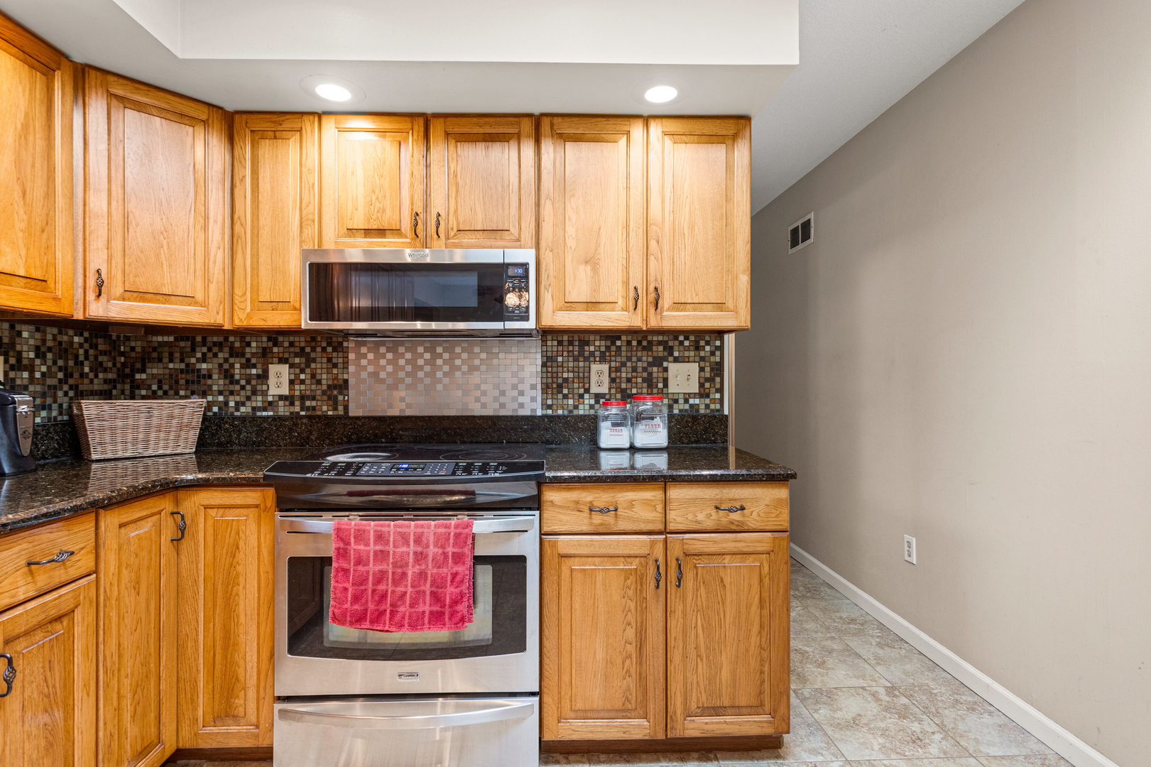2073 Coyote Run Road Monticello, IL 61856 - Photo 13 of 42 a kitchen with stainless steel appliances granite countertop a stove a sink and a microwave