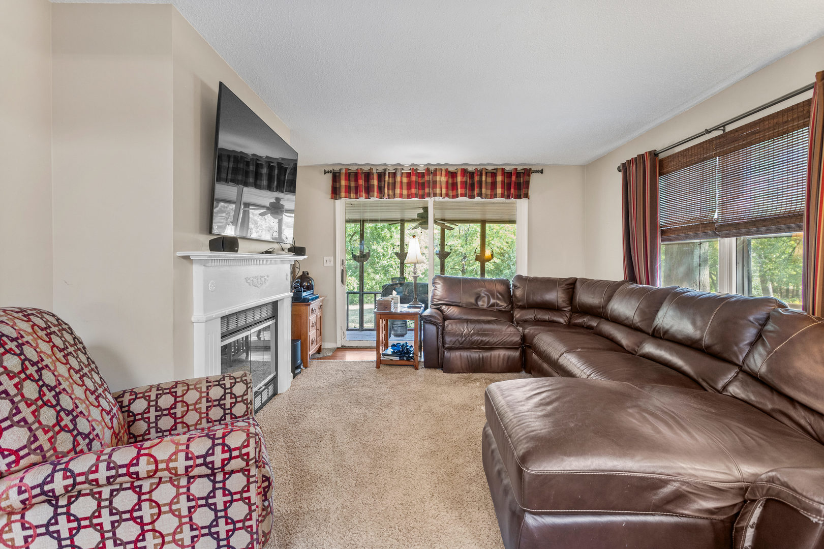 2073 Coyote Run Road Monticello, IL 61856 - Photo 16 of 42 a living room with furniture a fireplace and a large window