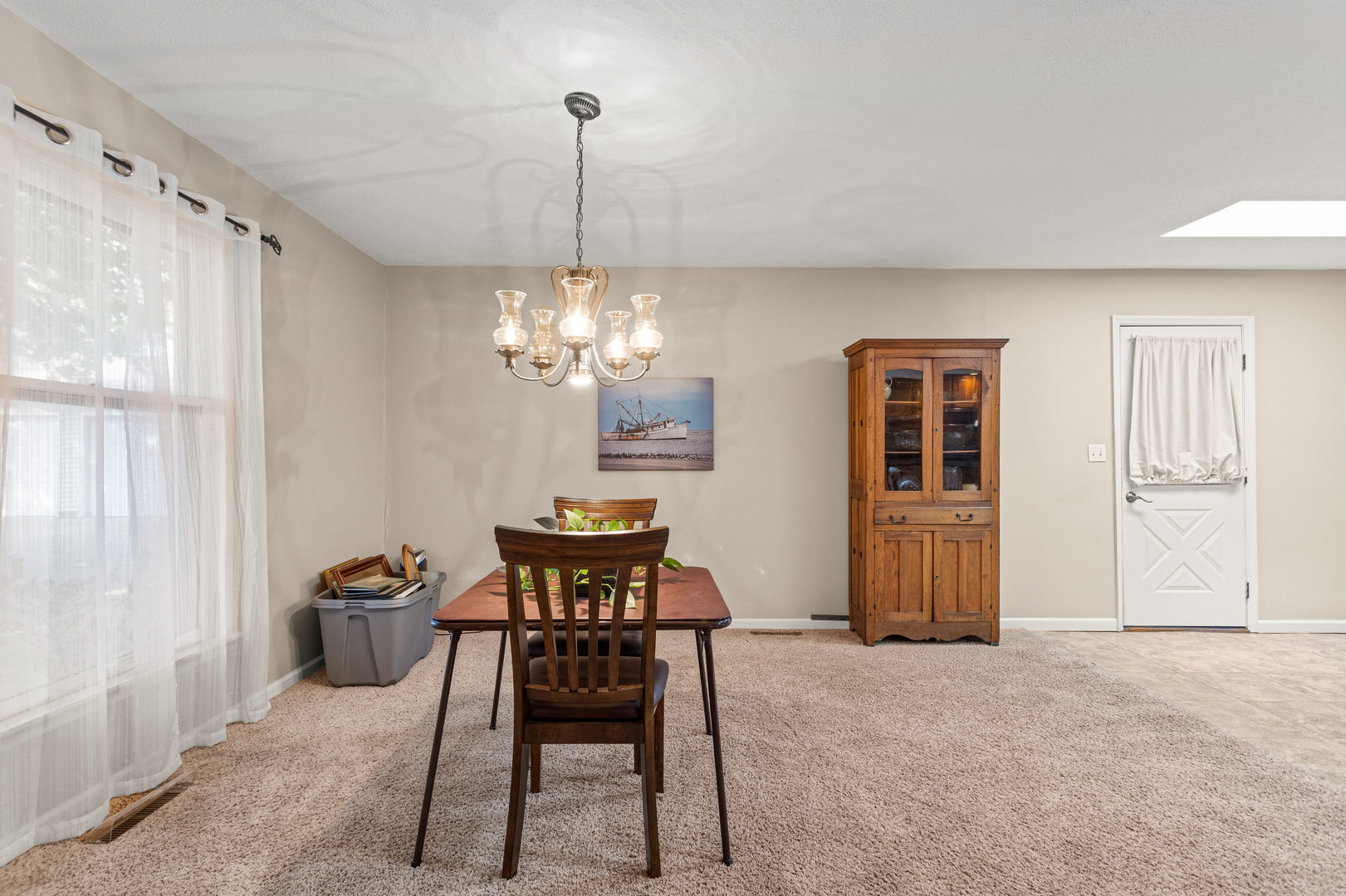 2073 Coyote Run Road Monticello, IL 61856 - Photo 8 of 42 a view of a dining room with furniture a chandelier and a window