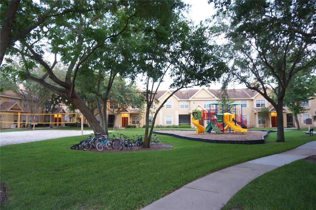 873 Grand Regency Pointe, Unit 105 Altamonte Springs, FL 32714 - Photo 20 of 24 a view of a house with garden and trees