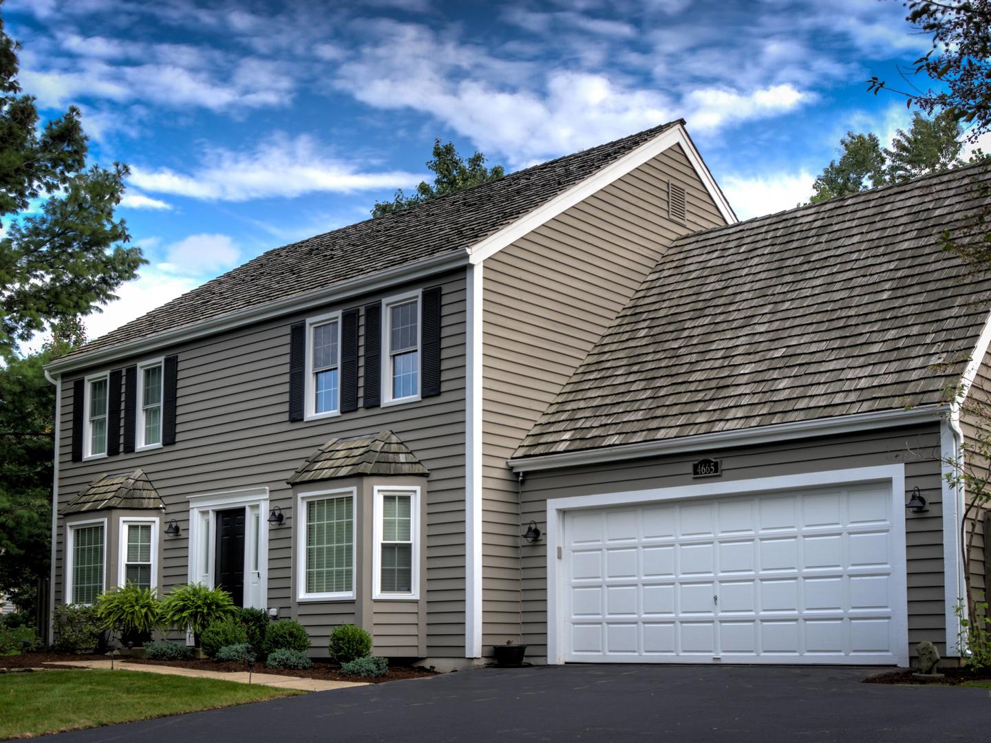 a view of brick house with a garage