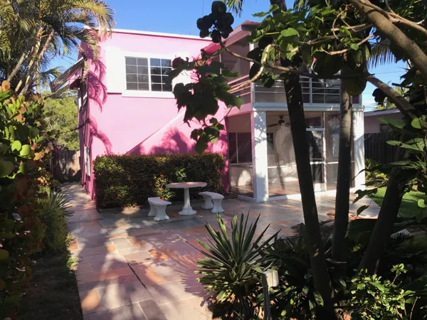 a view of a house with yard and sitting area