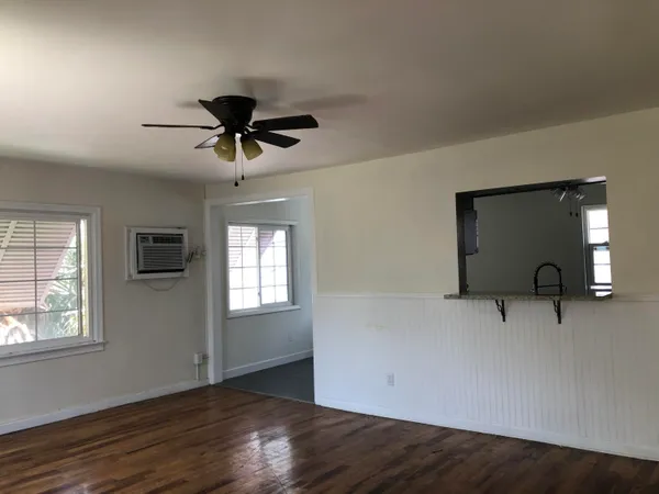 a view of a livingroom with a window and a ceiling fan