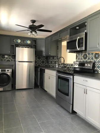 a kitchen with stainless steel appliances a stove a microwave and a refrigerator