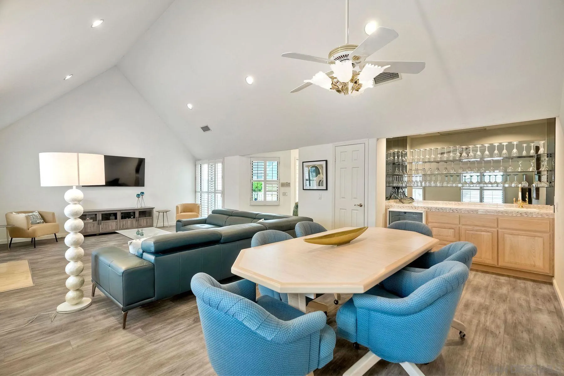 7635 Draper Avenue La Jolla, CA 92037 - Photo 24 of 43 a living room with furniture a chandelier and a flat screen tv