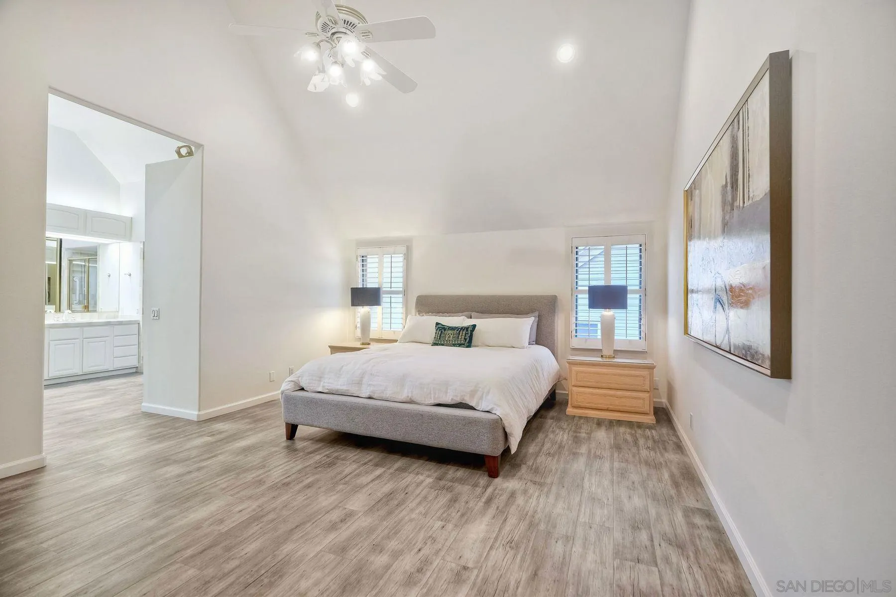 7635 Draper Avenue La Jolla, CA 92037 - Photo 27 of 43 a bedroom with a large bed and a chandelier