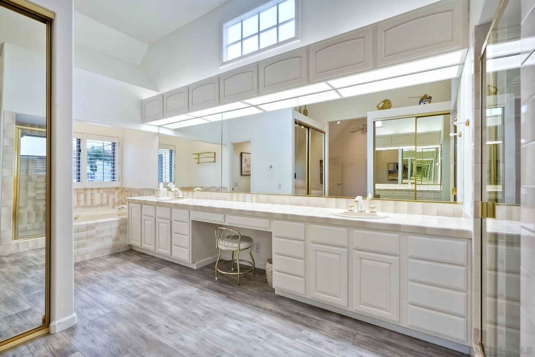 7635 Draper Avenue La Jolla, CA 92037 - Photo 30 of 43 a spacious bathroom with a double vanity sink a mirror and a bathtub