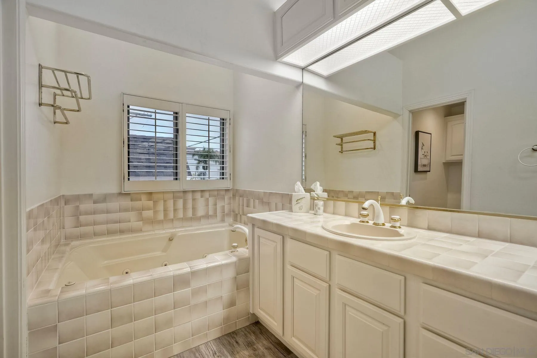 7635 Draper Avenue La Jolla, CA 92037 - Photo 32 of 43 a bathroom with a tub sink and mirror