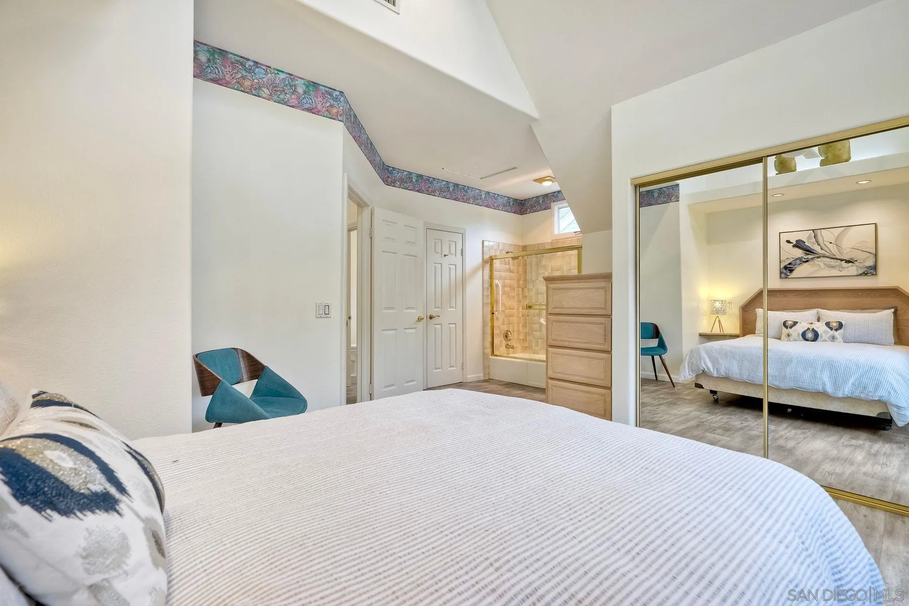 7635 Draper Avenue La Jolla, CA 92037 - Photo 35 of 43 a bedroom with a bed and a large mirror