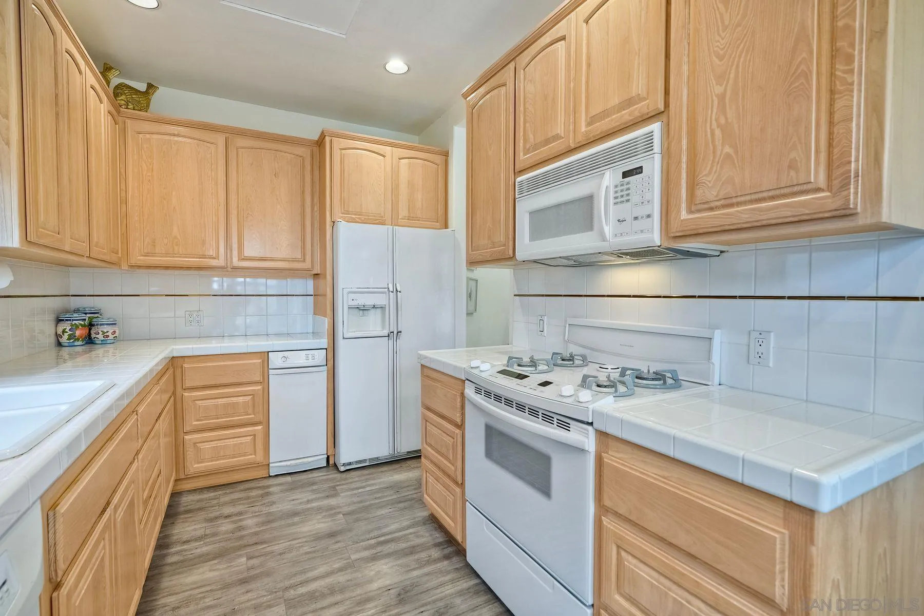 7635 Draper Avenue La Jolla, CA 92037 - Photo 38 of 43 a kitchen with stainless steel appliances granite countertop a sink stove and refrigerator