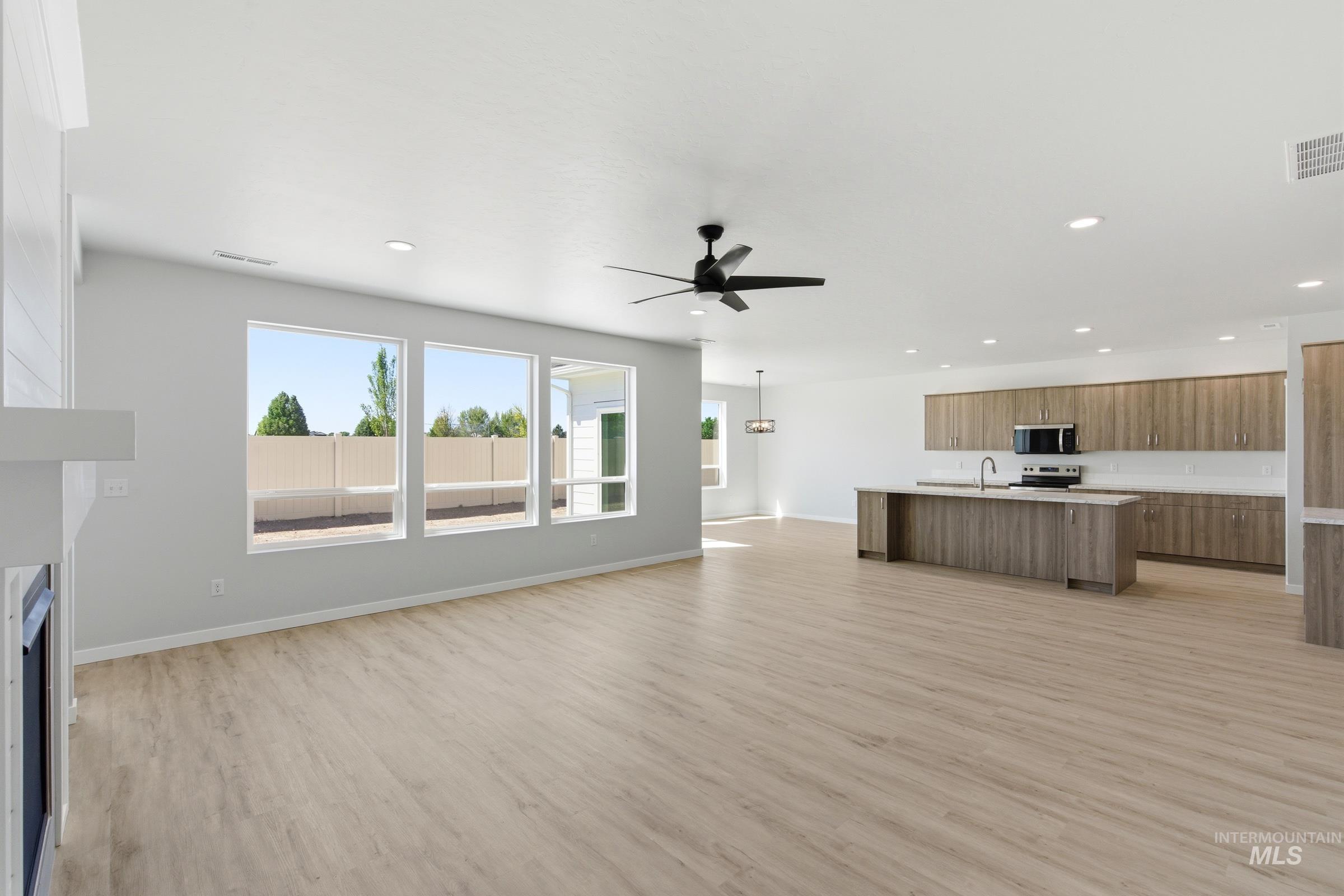 13663 Redway Court Caldwell, ID 83607 - Photo 15 of 32 Open-concept living space featuring wood-finish flooring, a contemporary ceiling fan, and recessed lighting