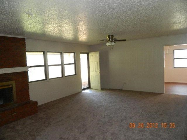6902 Flint Avenue Lubbock, TX 79413 - Photo 2 of 10 an empty room with windows